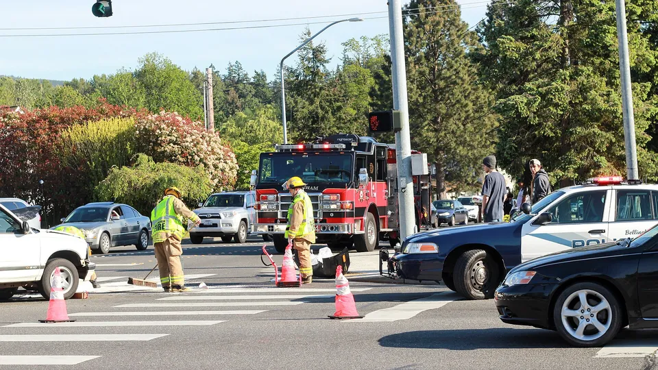 Police and fire crews at a car accident at a city intersection