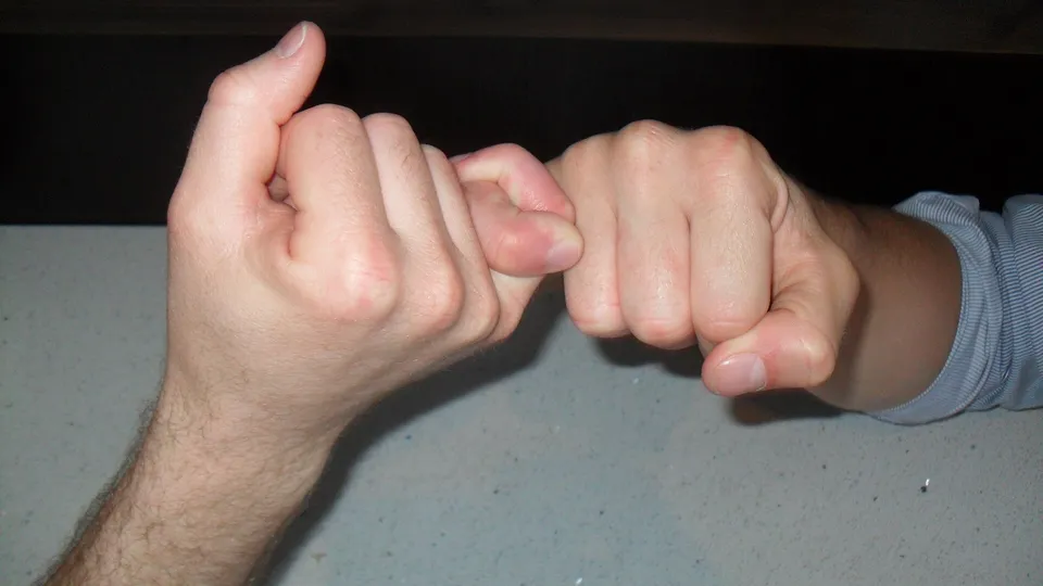 Two hands making a pinky promise